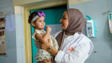 EIne Frau hat ein Kind auf dem Arm