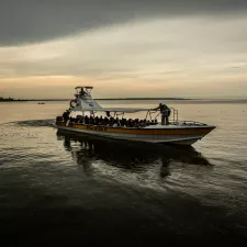 Menschen in einem Kahn auf einem breiten Fluss