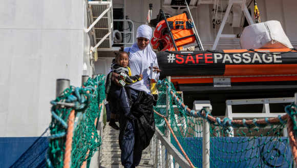Aus Seenot gerettete Mutter und Kind gehen von Bord der Geo Barents