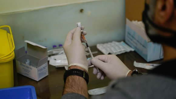 Medizinisches Personal zieht Spritzen mit Impfstoff gegen Covid-19 auf.