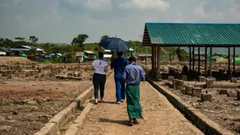 Unsere Teams unterstützen geflüchtete Rohingya in Myanmar. Myanmar: Mitarbeitende laufen über abgebrannten Marktplatz