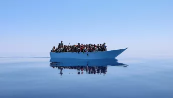 Ein mit Menschen überladenes Schiff in Seenot