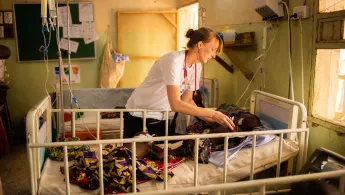 MSF Medical Doctor Valerie Weiss taking care of a young patient suffering from meningitis at Anka General Hospital, Nigeria. A doctor is taking care of a child.