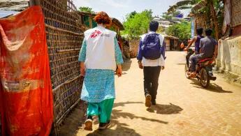 Zwei  unserer Mitarbeiter*innen in einem Rohingya-Geflüchtetetencamp. 