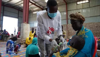 Mutter mit Kind und medizinischer Mitarbeiter