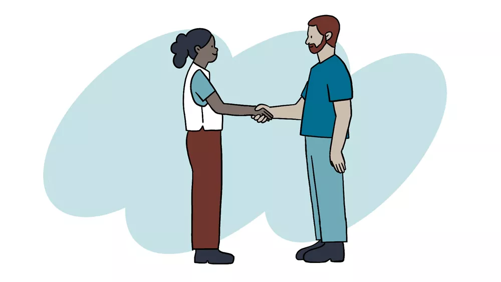 Mann und Frau schütteln Hände, sie trägt eine Weste von Ärzte ohne Grenzen