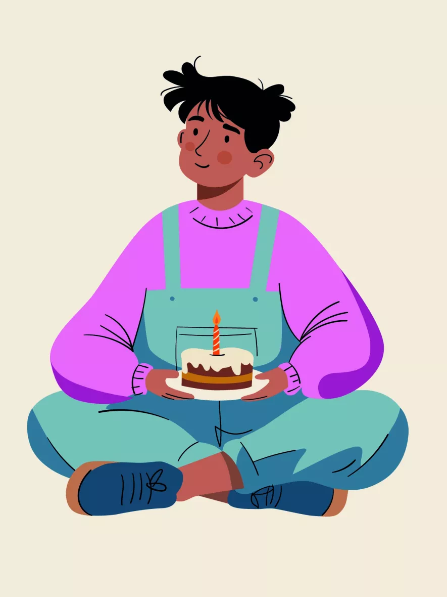 Person sitzt mit Geburtstagskuchen in der Hand