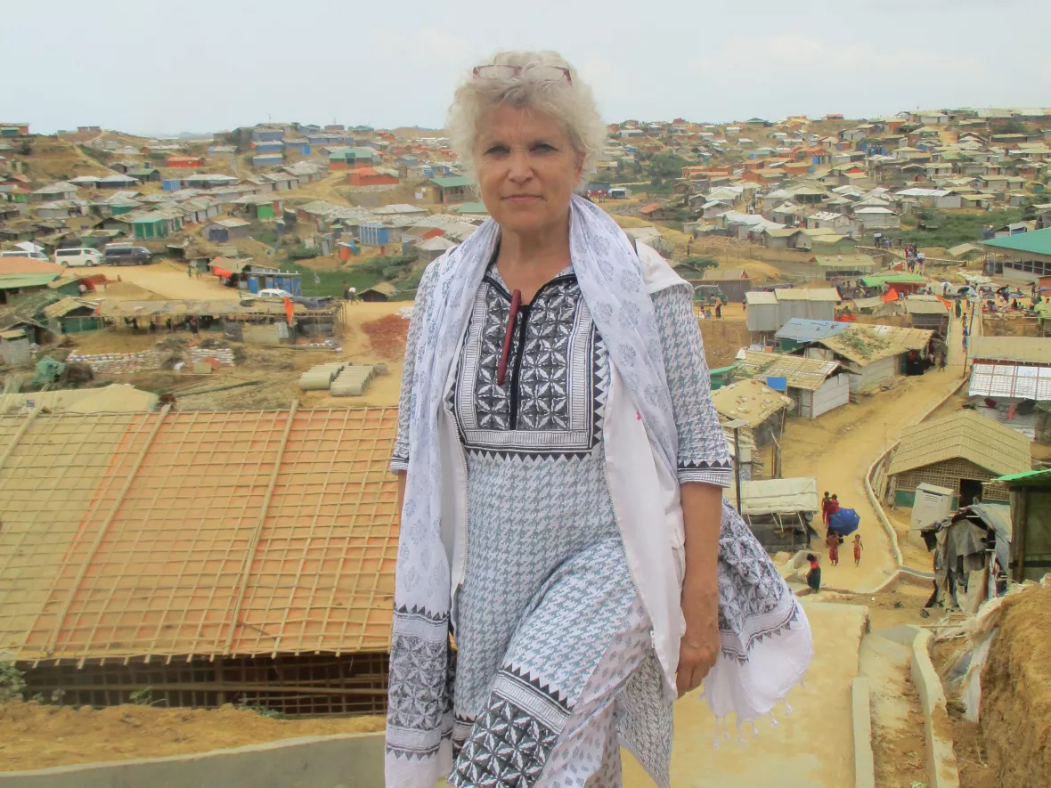 Heidi Anguria läuft Treppen hoch; im Hintergrund sind viele Hütten zu sehen
