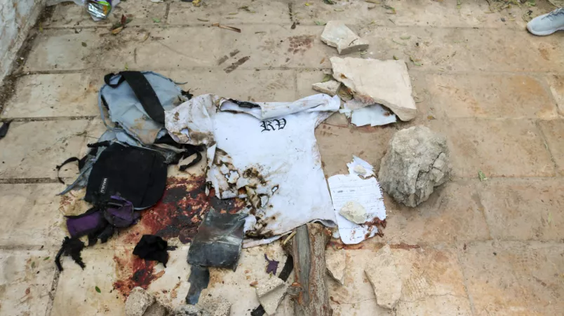 Blutige Stofffetzen neben Trümmern