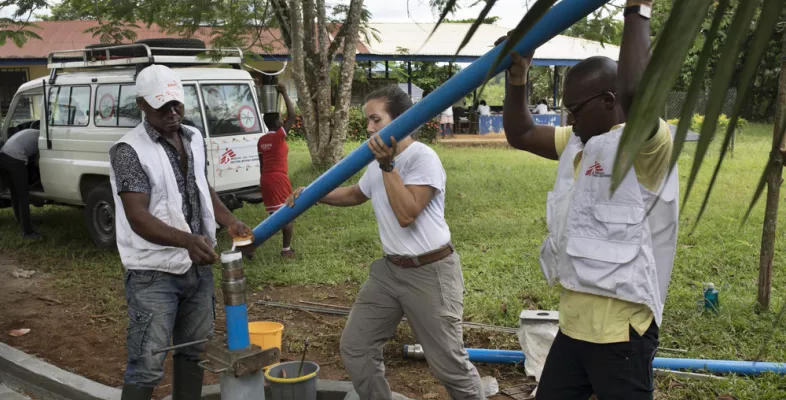 Drei Techniker*innen installieren eine Wasserpumpe in Nigeria.