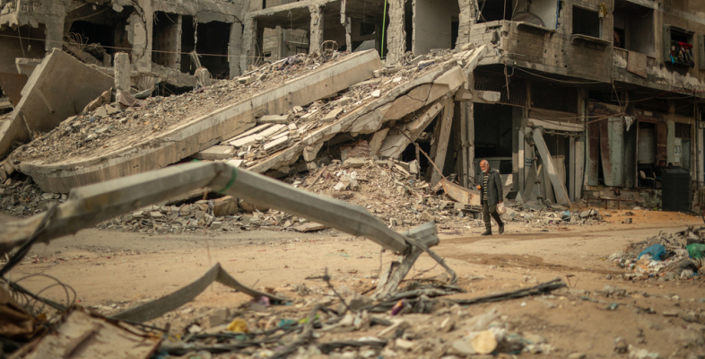 Ein Mann läuft durch eine zerstörte Nachbarschaft im Gazastreifen
