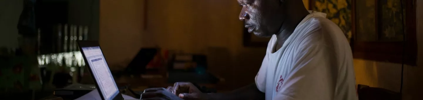 Jean Liyolongo, Head of Monga Intervention, works late into the night at the MSF base, Monga, in Bas-Uele Province, Democratic Republic of Congo. Jean Liyolongo, Head of Monga Intervention, works late into the night at the MSF base, Monga, in Bas-Uele Province, Democratic Republic of Congo.