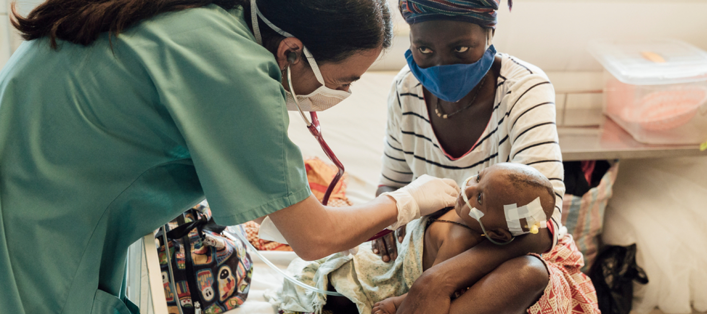 Ärztin Marianella Rodríguez untersucht eine sehr junge Patient*in auf der Intensivstation eines Krankenhauses in Sierra Leone. Ärztin untersucht Baby auf Intensivstation