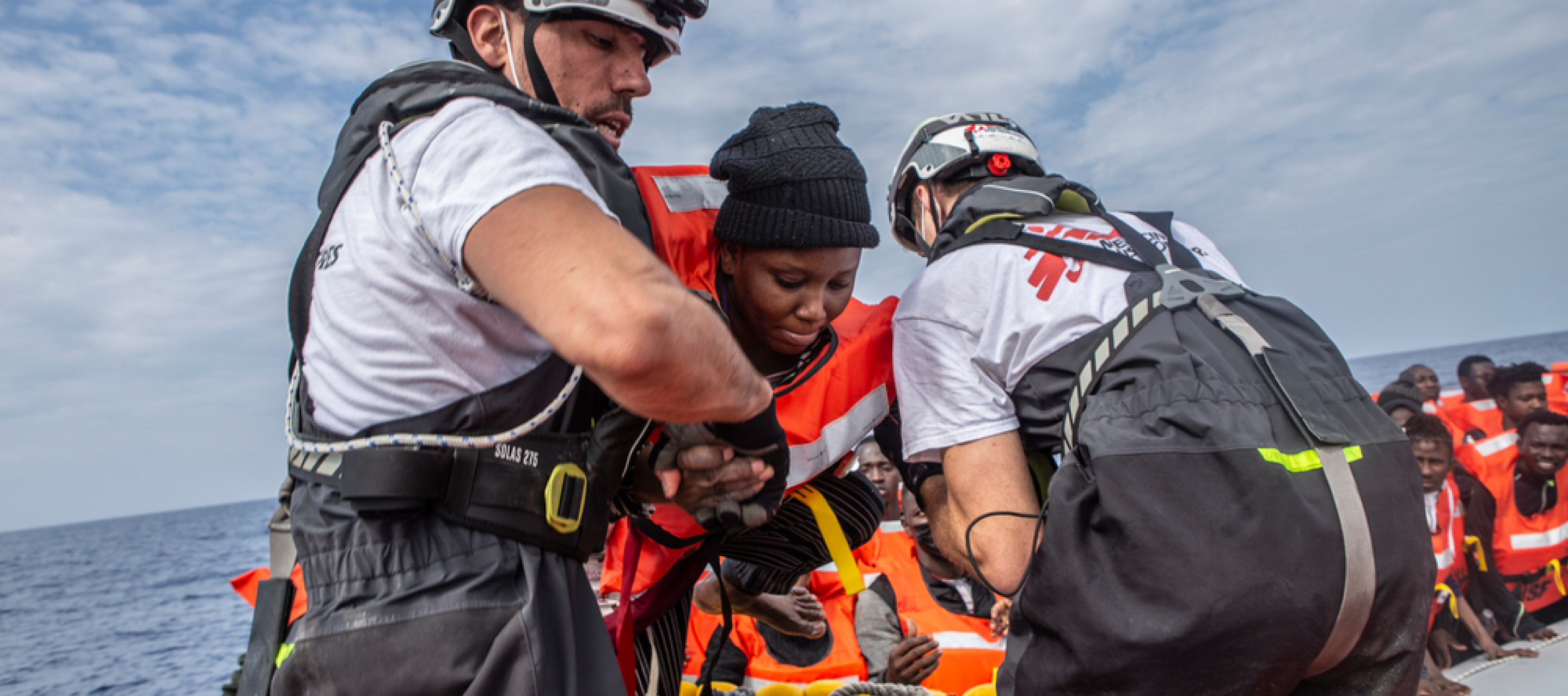 Geo Barents: Rettungsaktion auf dem Mittelmeer Zwei Mitarbeiter von Ärzte ohen Grenzen helfen den Menschen an Board der Geo Barents zu kommen