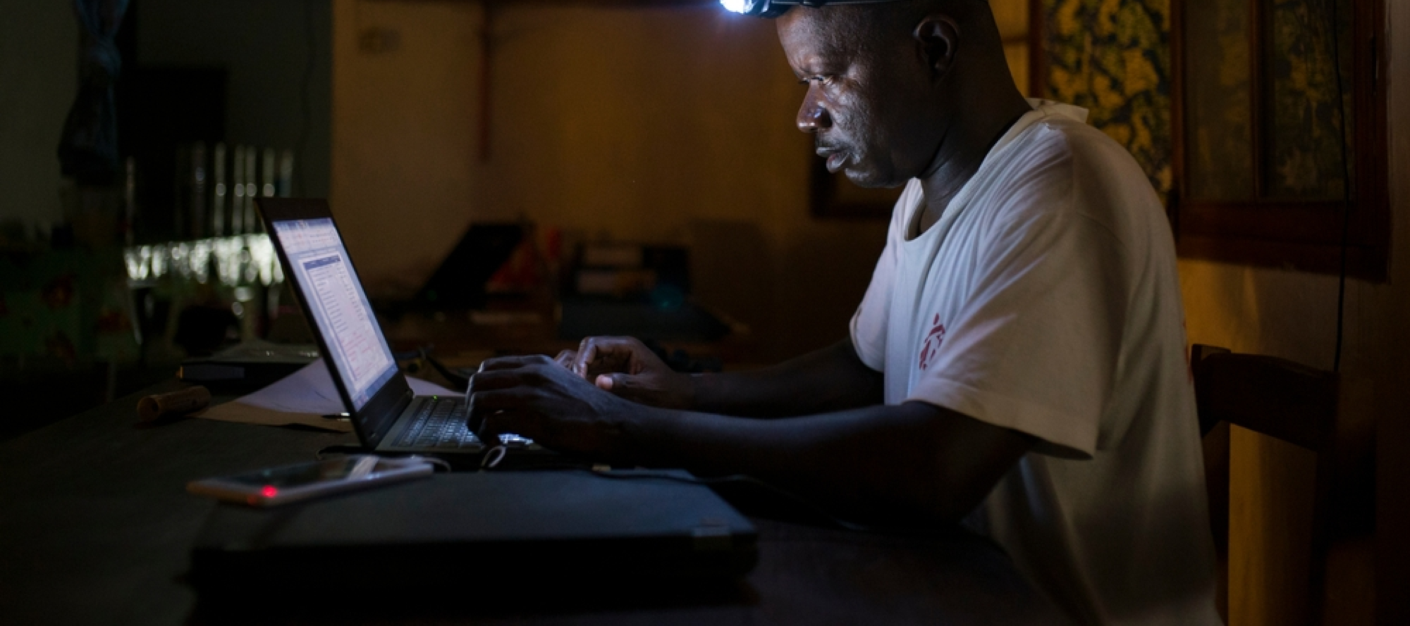 Jean Liyolongo, Head of Monga Intervention, works late into the night at the MSF base, Monga, in Bas-Uele Province, Democratic Republic of Congo.