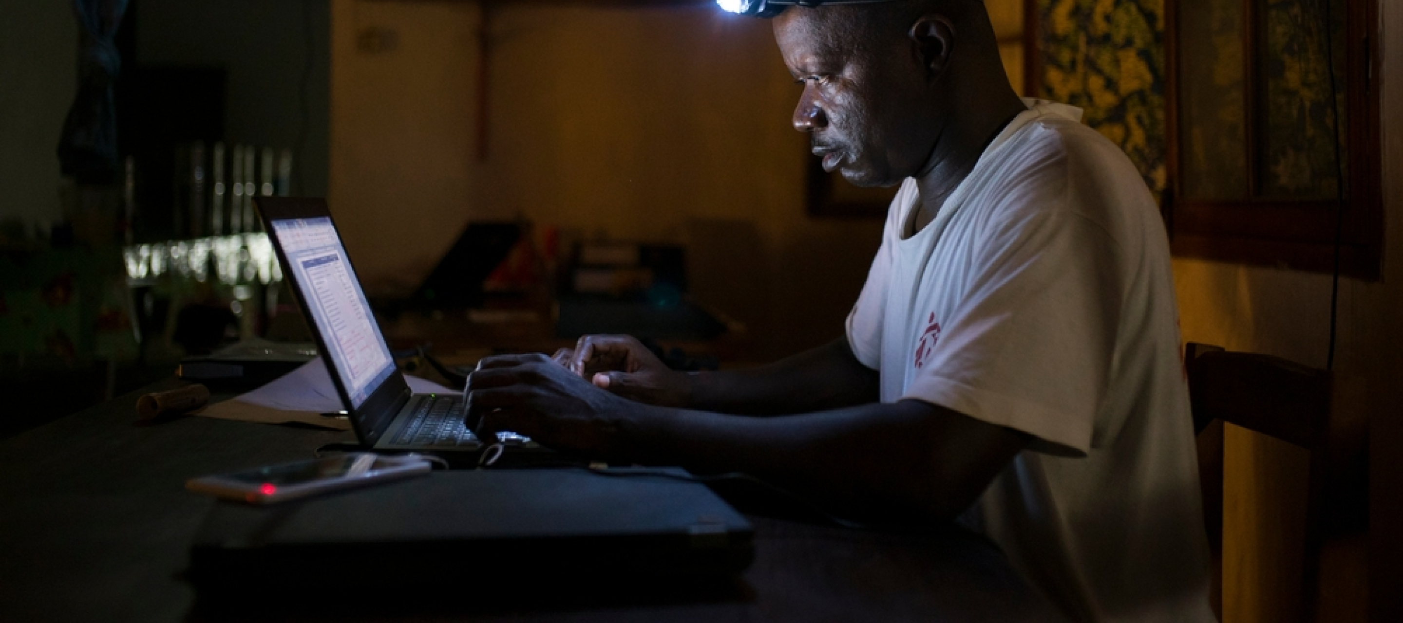 Jean Liyolongo, Head of Monga Intervention, works late into the night at the MSF base, Monga, in Bas-Uele Province, Democratic Republic of Congo. Jean Liyolongo, Head of Monga Intervention, works late into the night at the MSF base, Monga, in Bas-Uele Province, Democratic Republic of Congo.