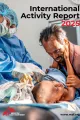 Kind auf Behandlungstisch, daneben Mitarbeitende und Angehöriger