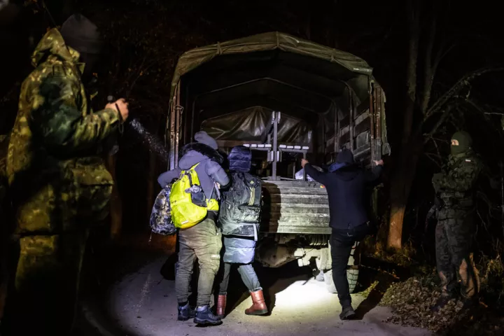 Militärfahrzeug und Geflüchtete an der Grenze zu Polen