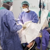 Medizinsches Personal führt einen Kaiserschnitt bei einer Frau durch.