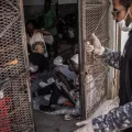 A guard is closing the door of a cell in Abu Salim detention center, in Tripoli, Libya.