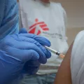 Medizinisches Personal impft eine Person gegen Covid-19. 